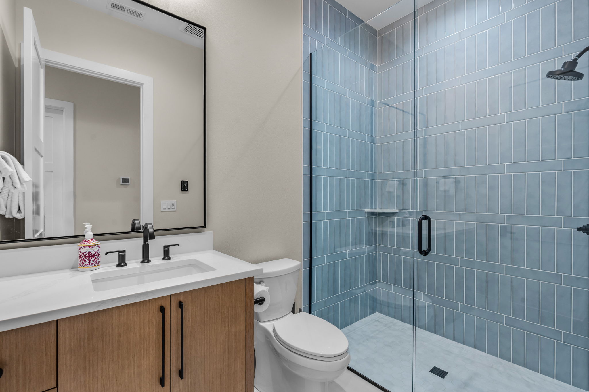Full bathroom with walk-in shower.