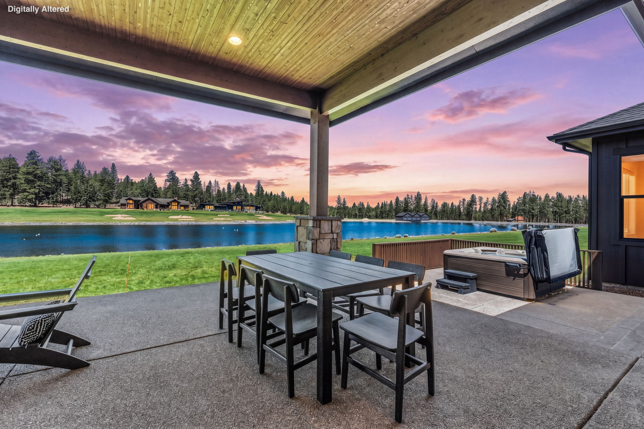 The covered outdoor patio is made for gathering — dining for 8, natural gas fire pit, private hot tub, space heater, and a natural gas BBQ, all with Tanager Lake as your backdrop.