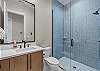 Full bathroom with walk-in shower.