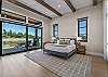 Wake up to sweeping Tanager Lake views — the primary suite features a king bed, gas fireplace, private patio access, and a spa-like ensuite with soaking tub, dual-head tiled shower, and walk-in closet.