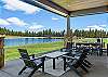 The covered outdoor patio is made for gathering — dining for 8, natural gas fire pit, private hot tub, space heater, and a natural gas BBQ, all with Tanager Lake as your backdrop.
