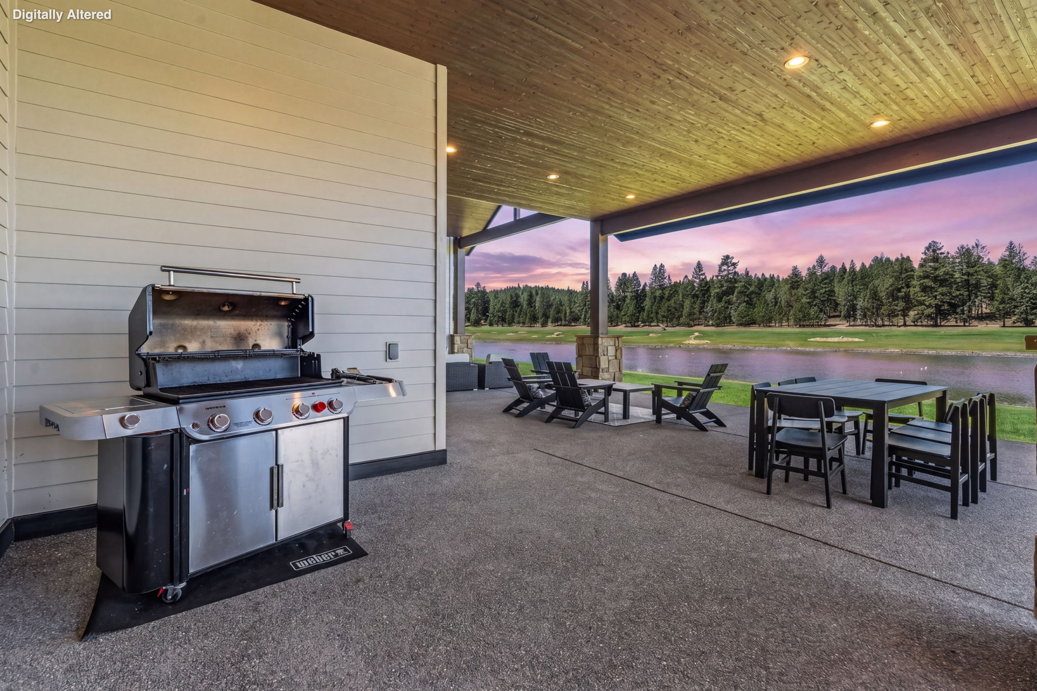 The covered outdoor patio is made for gathering — dining for 8, natural gas fire pit, private hot tub, space heater, and a natural gas BBQ, all with Tanager Lake as your backdrop.