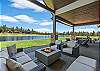 The covered outdoor patio is made for gathering — dining for 8, natural gas fire pit, private hot tub, space heater, and a natural gas BBQ, all with Tanager Lake as your backdrop.