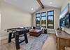 Game on. The media room features a queen sleeper sofa, large Smart TV, Xbox, and foosball table — the perfect wind-down after a day on the lake.