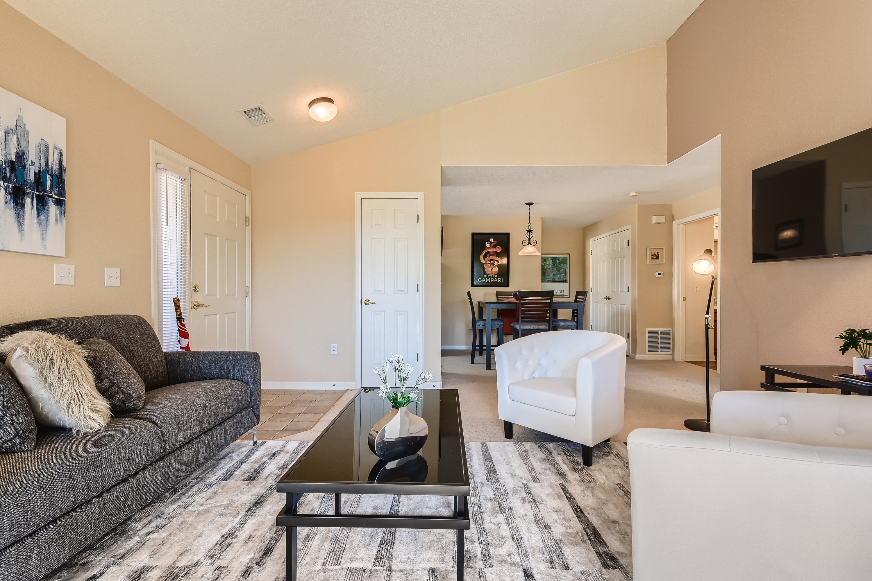 Cozy up in style! This living room is perfect for relaxation and gathering. Features a gas log fireplace and smart TV. 