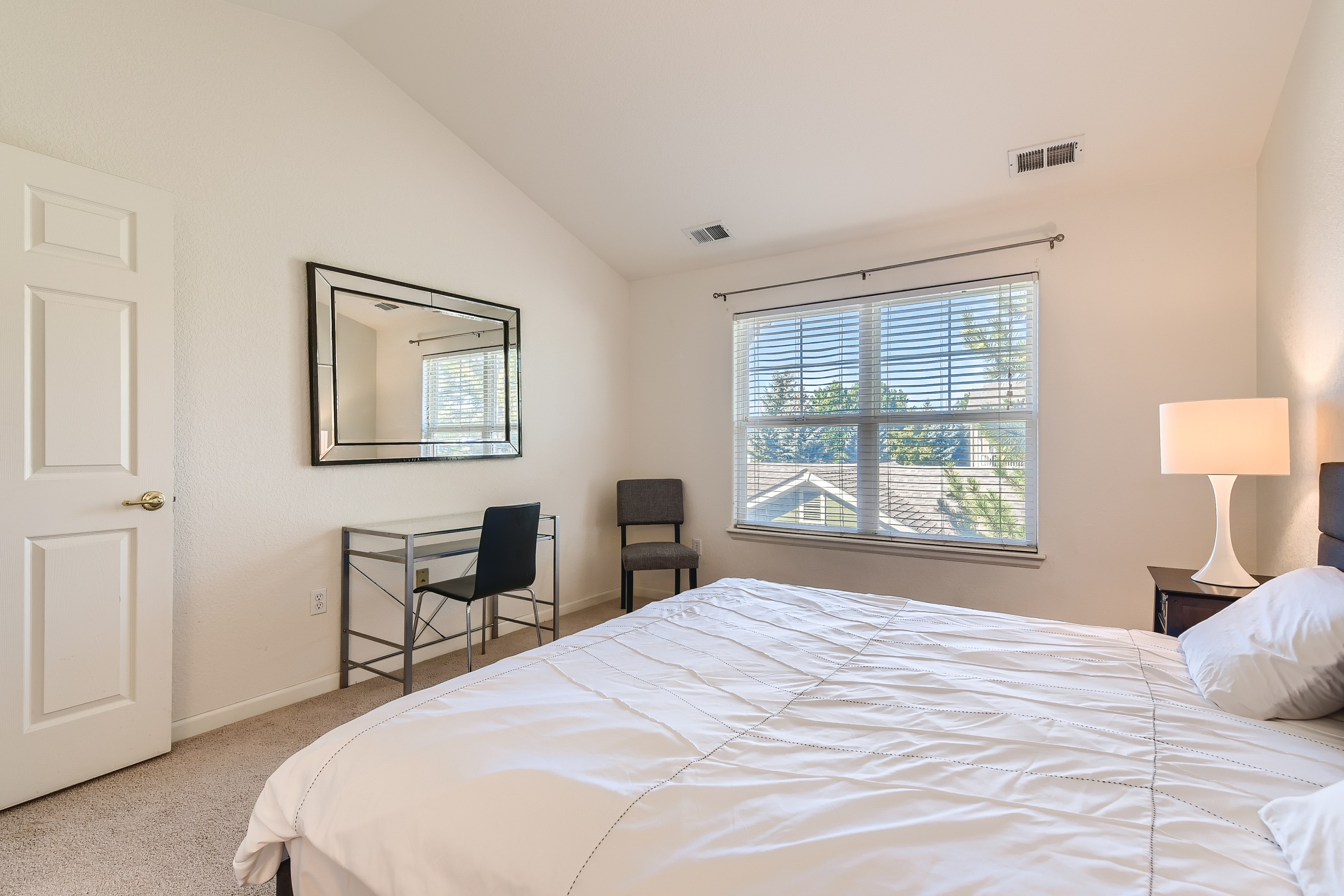 King bedroom with a desk for remote working. 