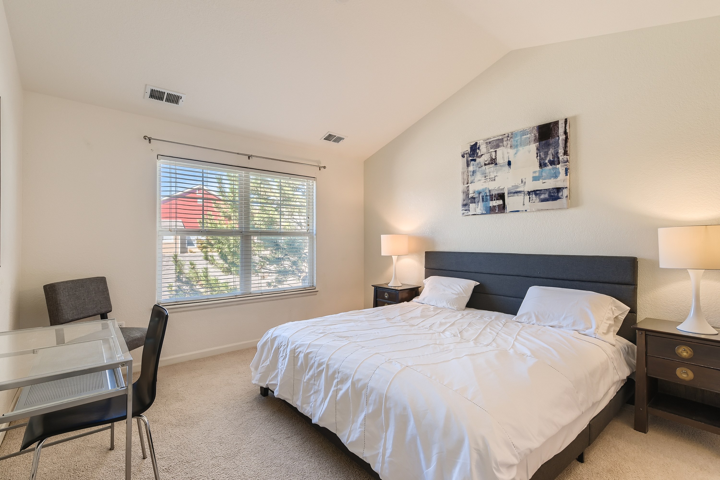 King bedroom with a desk for remote working. 