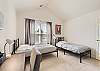 Guest bedroom featuring 2 twin beds and a desk. 