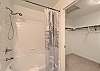Ensuite bathroom connected to the king bedroom, featuring a shower/tub combo and walk-in closet.