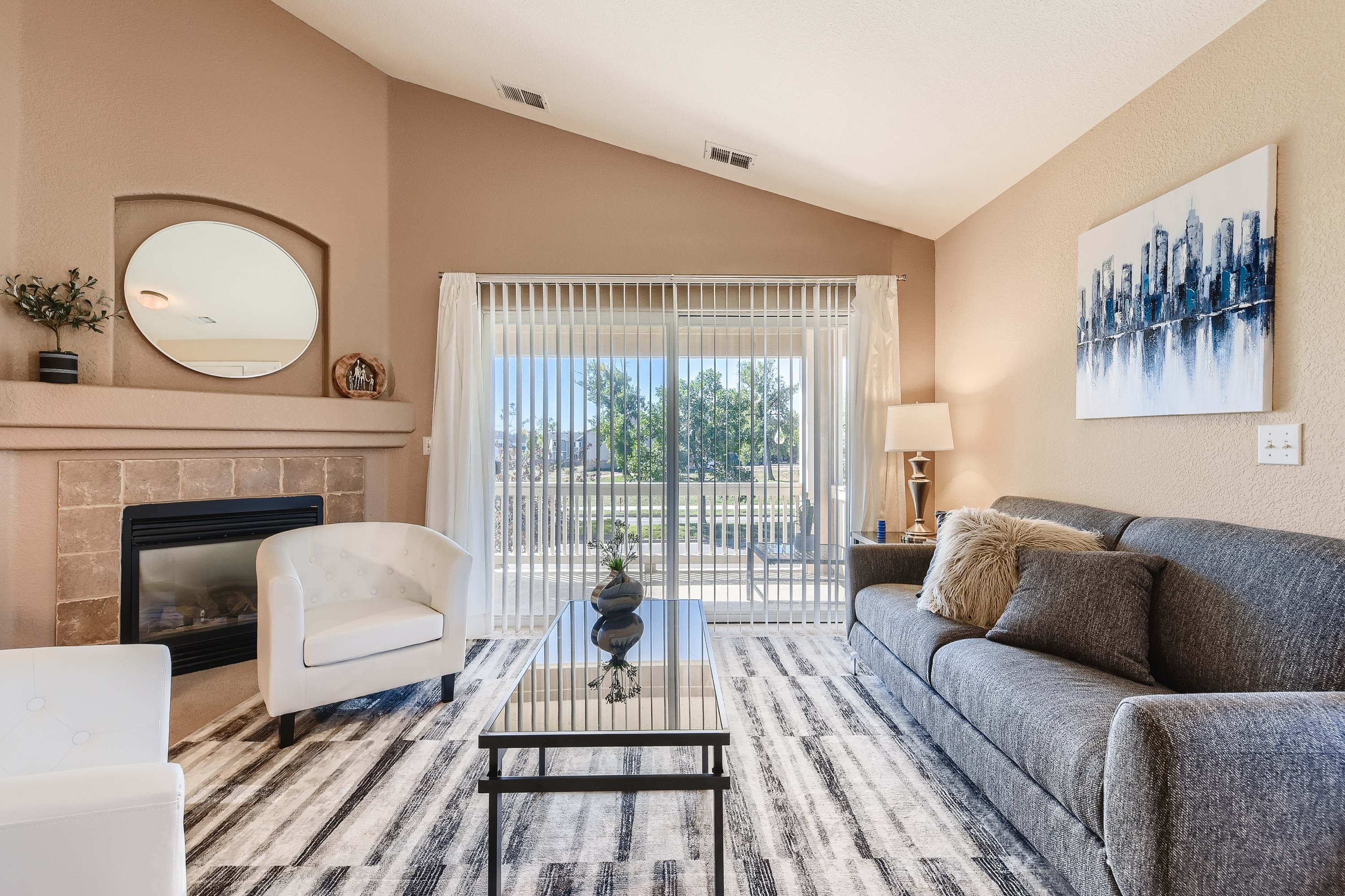 Cozy up in style! This living room is perfect for relaxation and gathering. Features a gas log fireplace and smart TV. 
