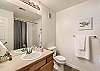 Clean and functional guest bathroom featuring a tub/shower combination.