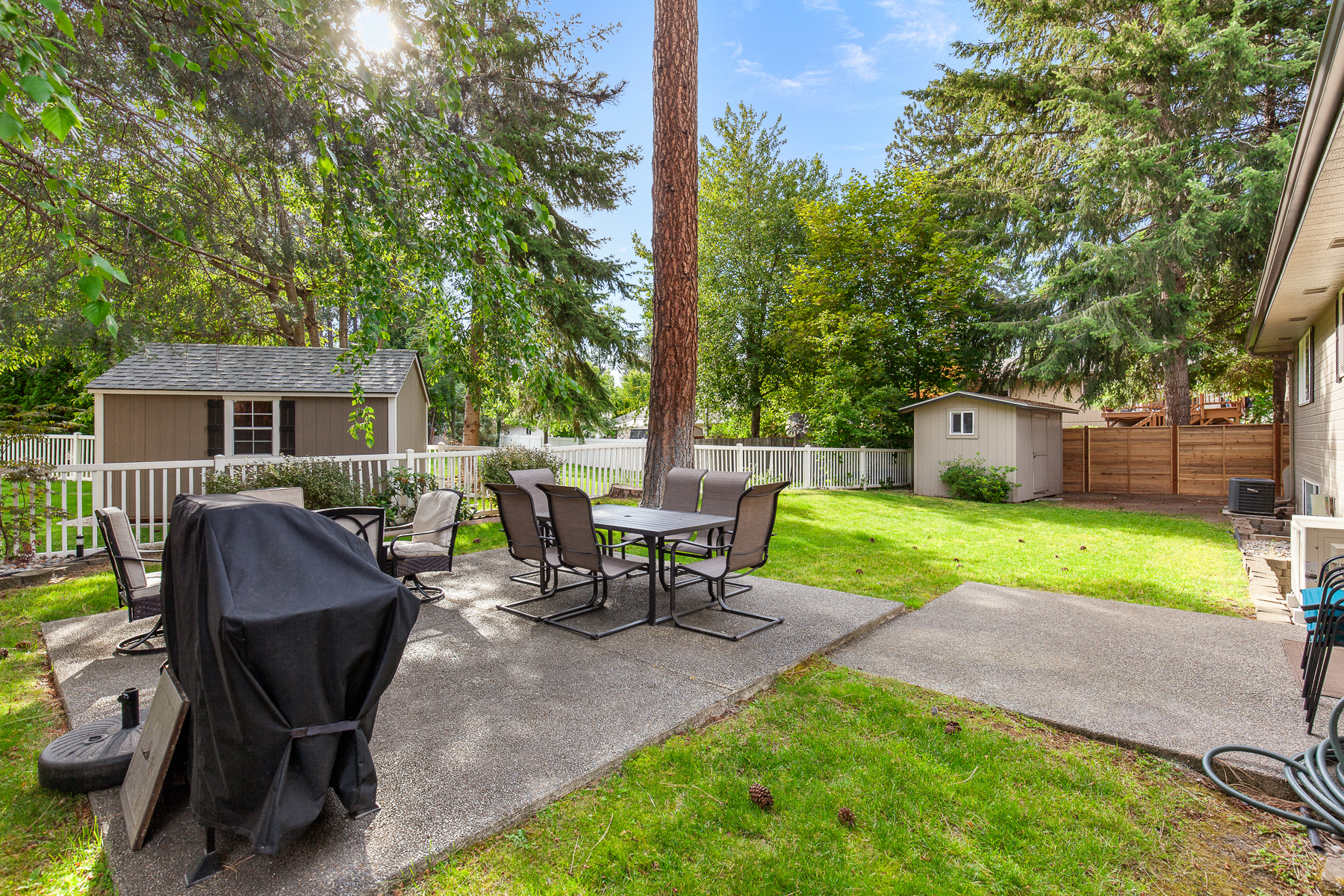 Private backyard – includes a fenced yard, fire pit table with seating for six, and a grill.