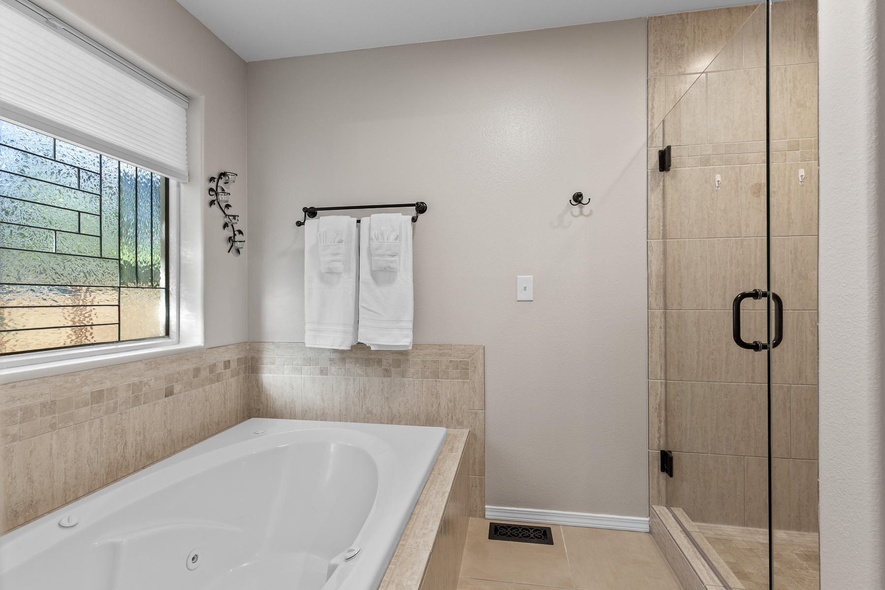 Main King bedroom ensuite bathroom with tub and walk-in shower.