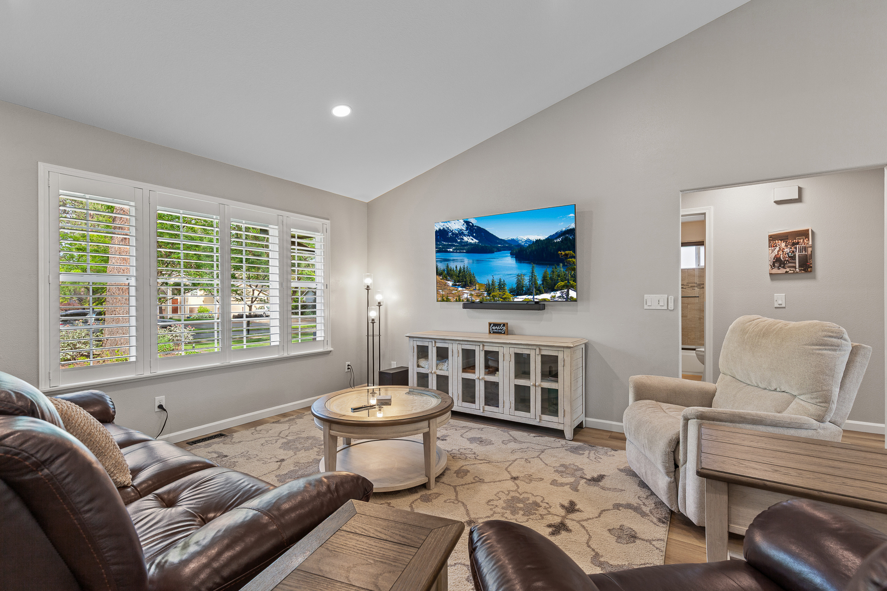 Living Room 1: Upper level living room with large smart TV and plenty of seating. 