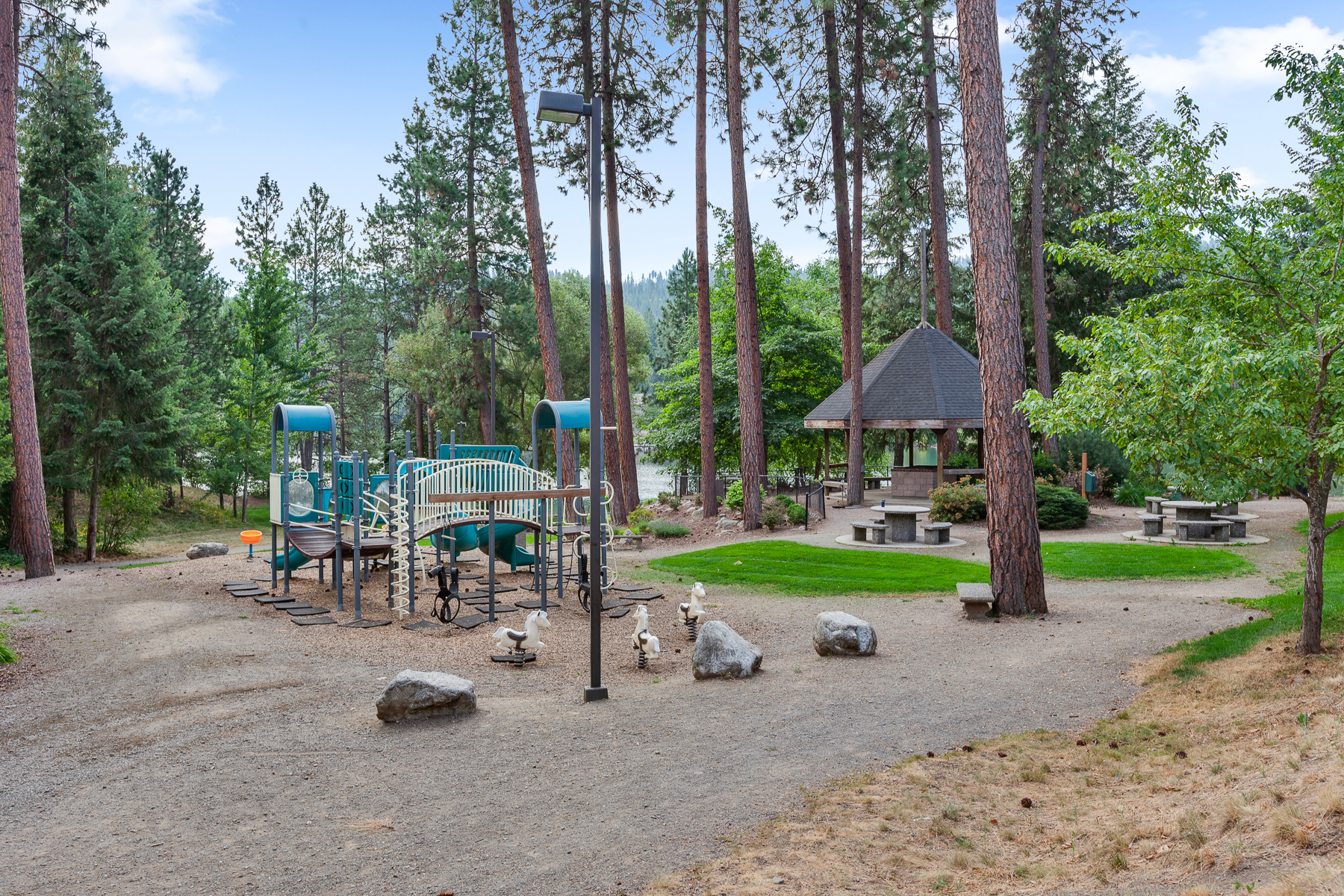 Community park — complete with a playground, picnic area, walking trails, and a private beach area on the Spokane River.