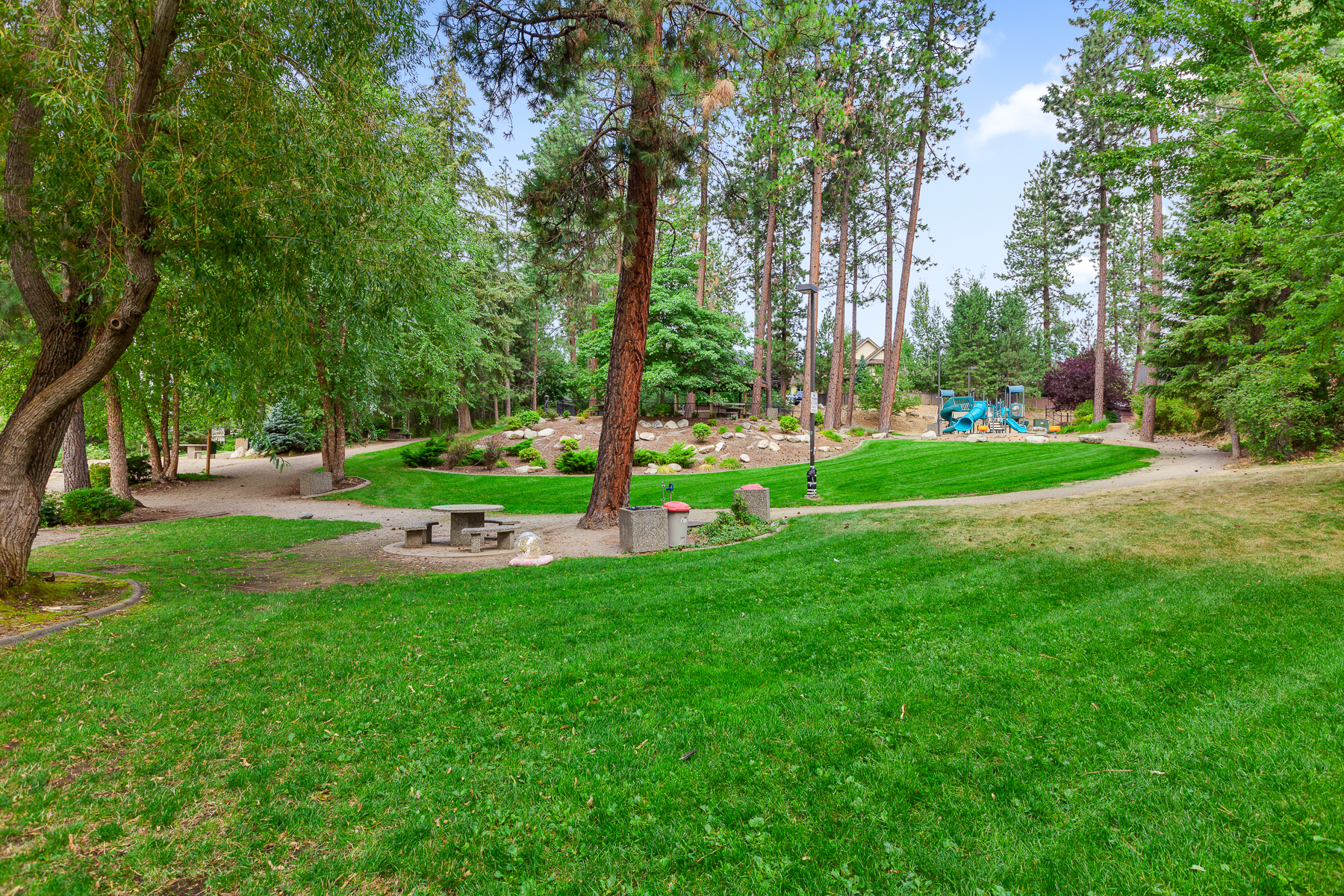 Community park — complete with a playground, picnic area, walking trails, and a private beach area on the Spokane River.
