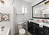 Full bathroom with convenient tub/shower combo and modern finishes.