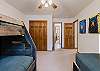 Third bedroom on the upper level with a twin bunk bed and an additional twin bed. 