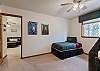 Third bedroom on the upper level with a twin bunk bed and an additional twin bed. 