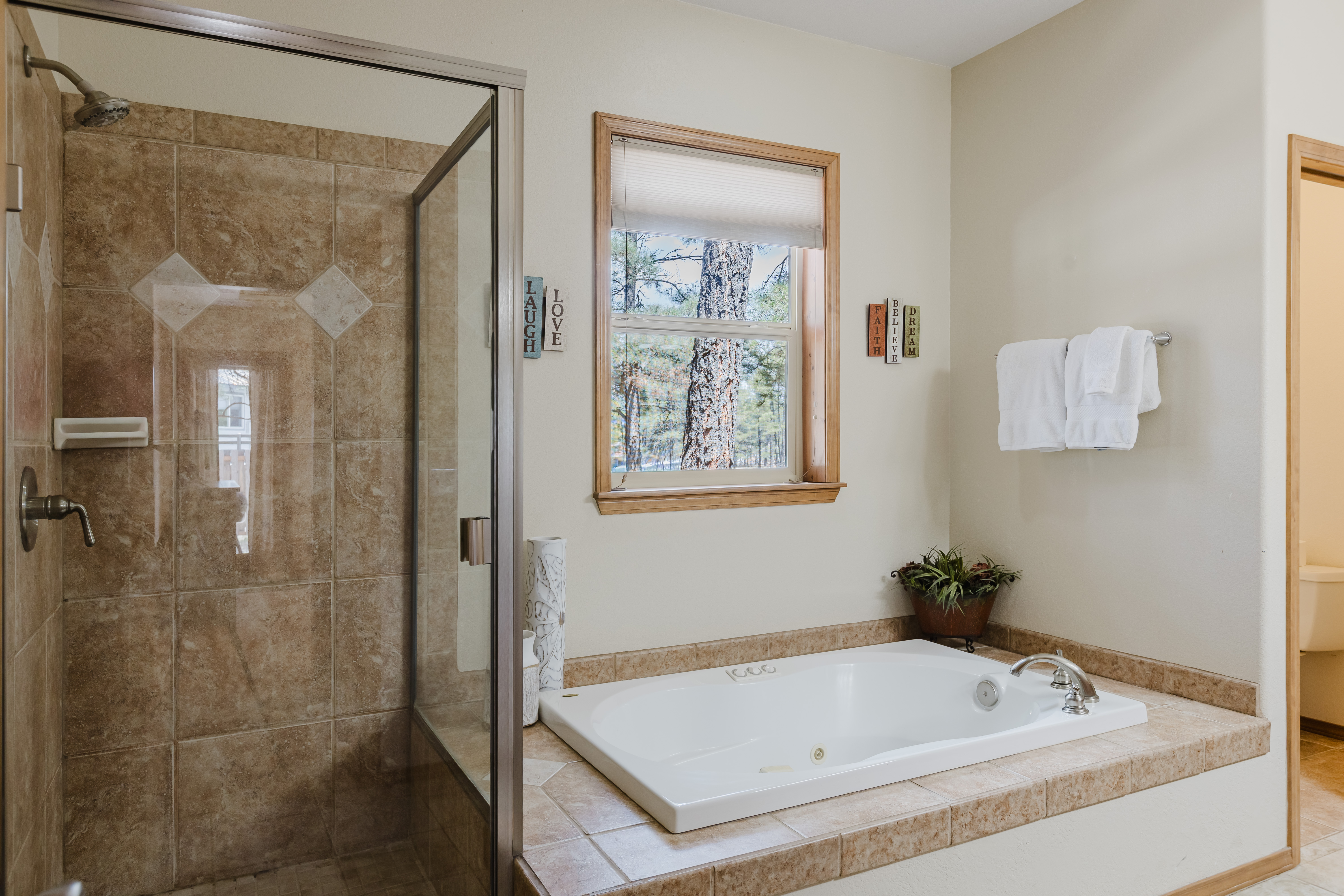 Main bedroom ensuite bathroom with dual vanities, walk-in shower, and soaking tub.