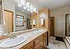 Main bedroom ensuite bathroom with dual vanities, walk-in shower, and soaking tub.