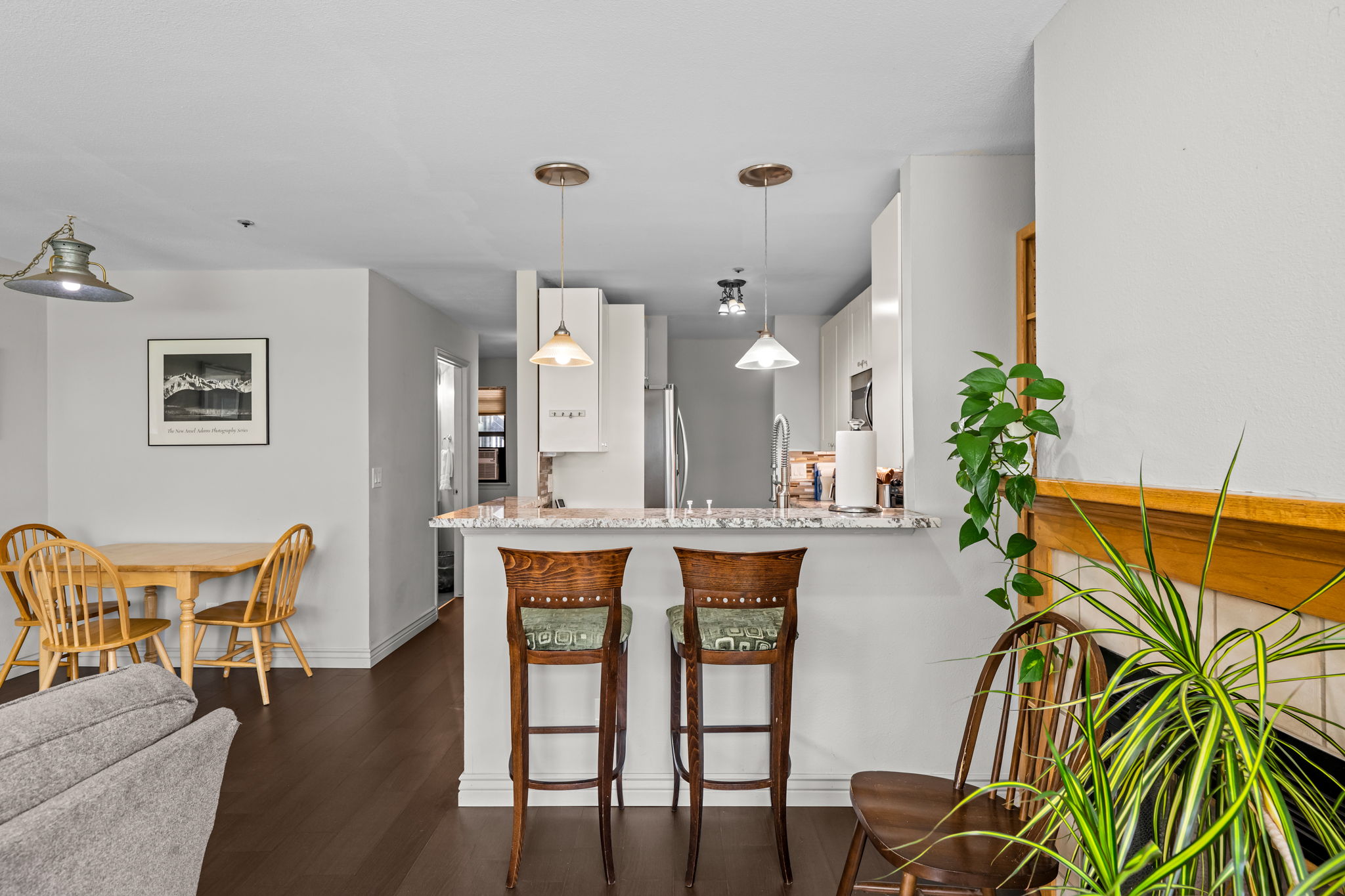 Dining table for 3 and bar seating for 2. 