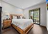 Queen bed, ensuite bathroom with dual sinks and glass shower, private deck access.