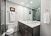 Queen bed, ensuite bathroom with dual sinks and glass shower, private deck access.