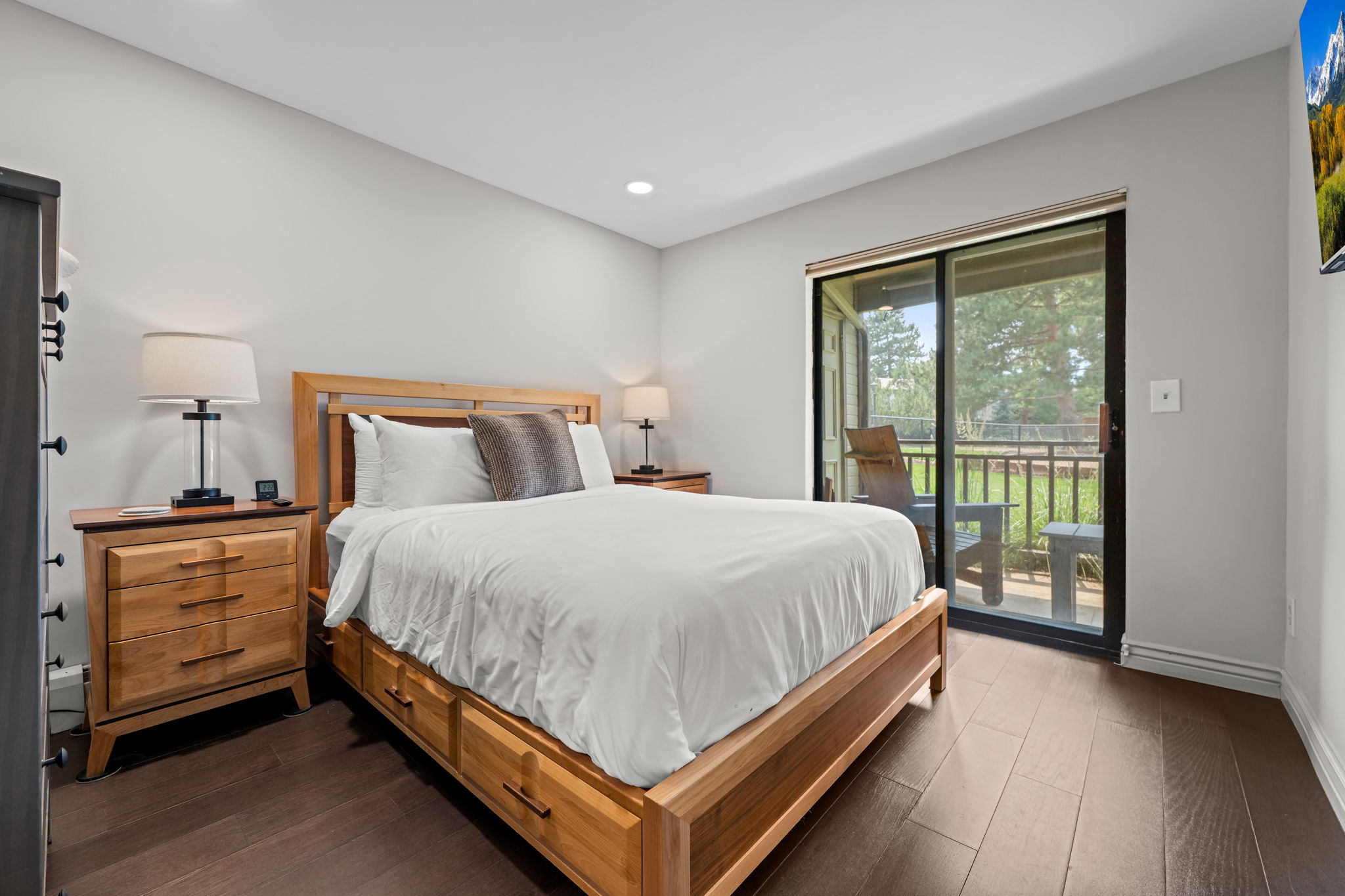 Queen bed, ensuite bathroom with dual sinks and glass shower, private deck access.