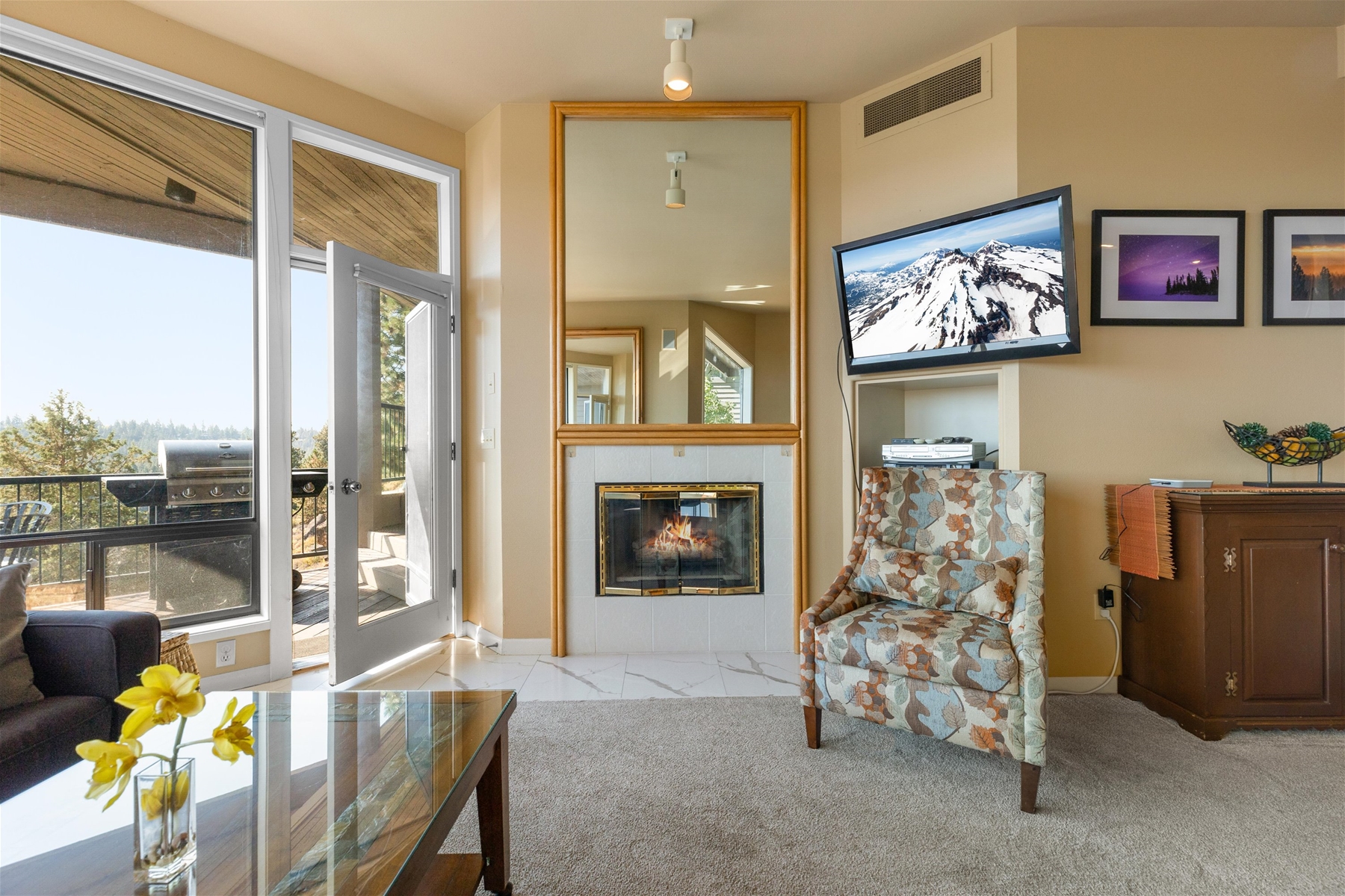 Cozy up by the fireplace and enjoy river views right out the large windows in the living room area. 