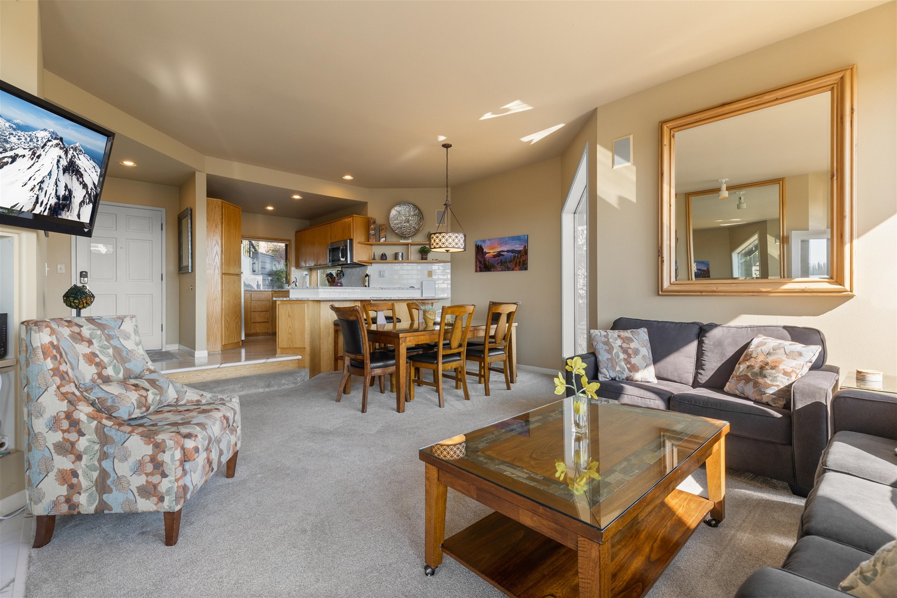 Open concept space – living room, dining area, and kitchen. 