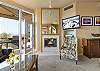 Cozy up by the fireplace and enjoy river views right out the large windows in the living room area. 