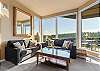 Living room with sleeper sofa and gorgeous river views out the window. 