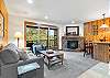 Comfortable and bright open living room area with gas fireplace and smart TV.