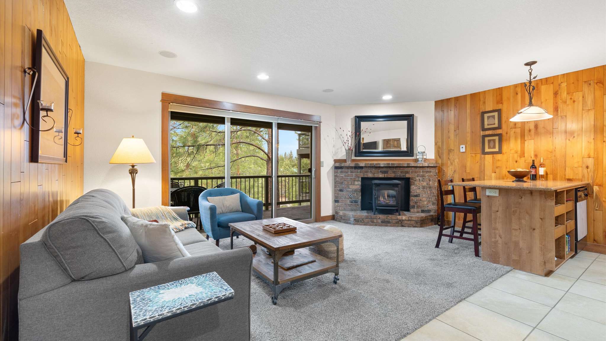 Comfortable and bright open living room area with gas fireplace and smart TV.