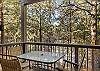 Outdoor dining area with views of the pines. 