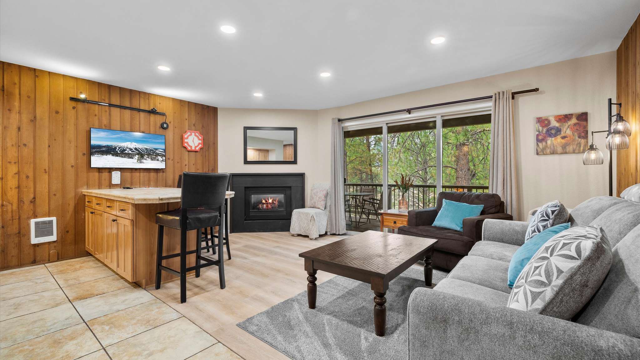 Open living room with gas fireplace, smart TV and comfortable sleeper sofa.