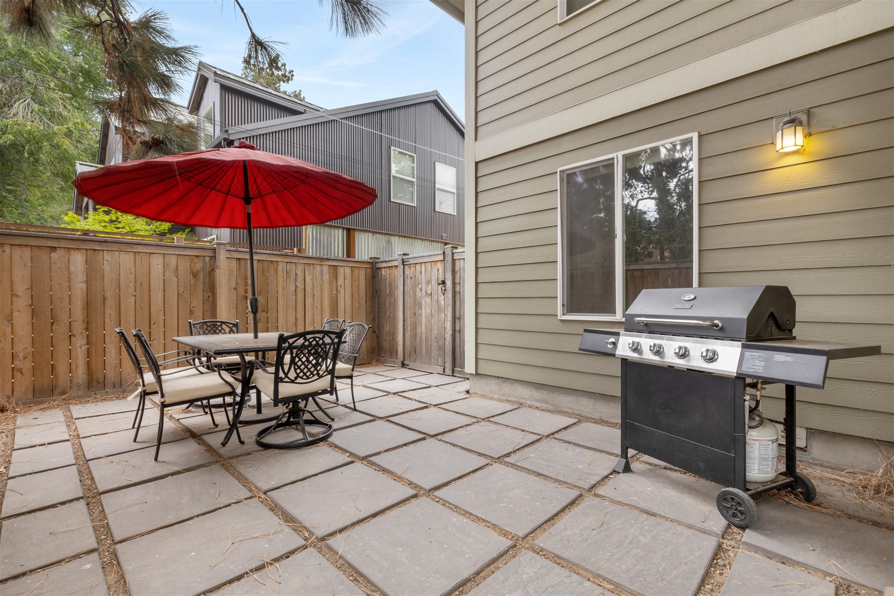 Outdoor patio with gas grill and seating for 6. 