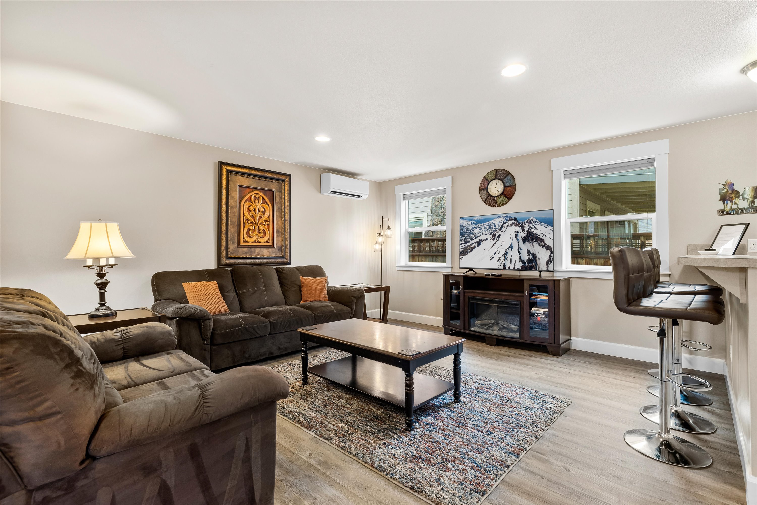 Living room with a smart TV and breakfast bar for three. 