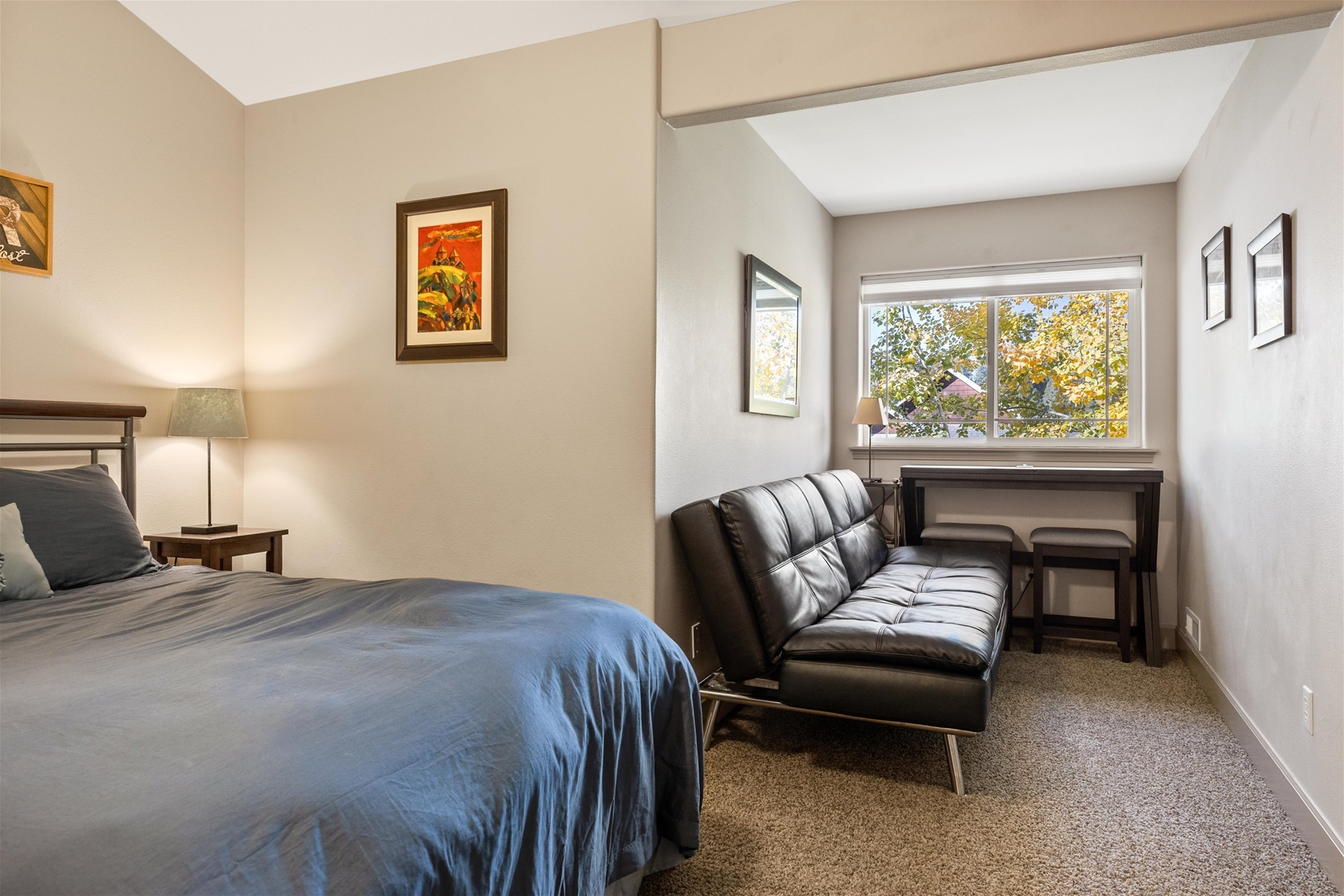 Queen guest room with sofa and work space, upper level.