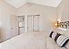 King guest room with ceiling fan, upper level.