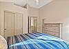 Queen guest room with ceiling fan, upper level.