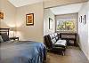 Queen guest room with sofa and work space, upper level.