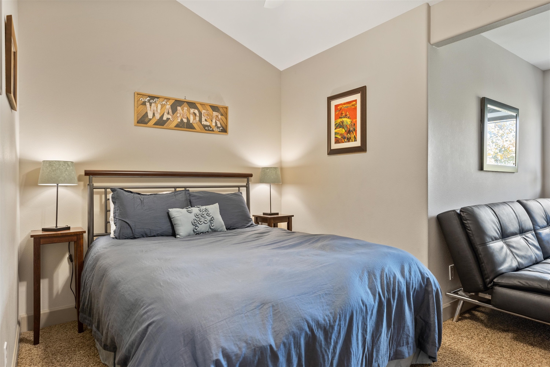Queen guest room with sofa and work space, upper level.