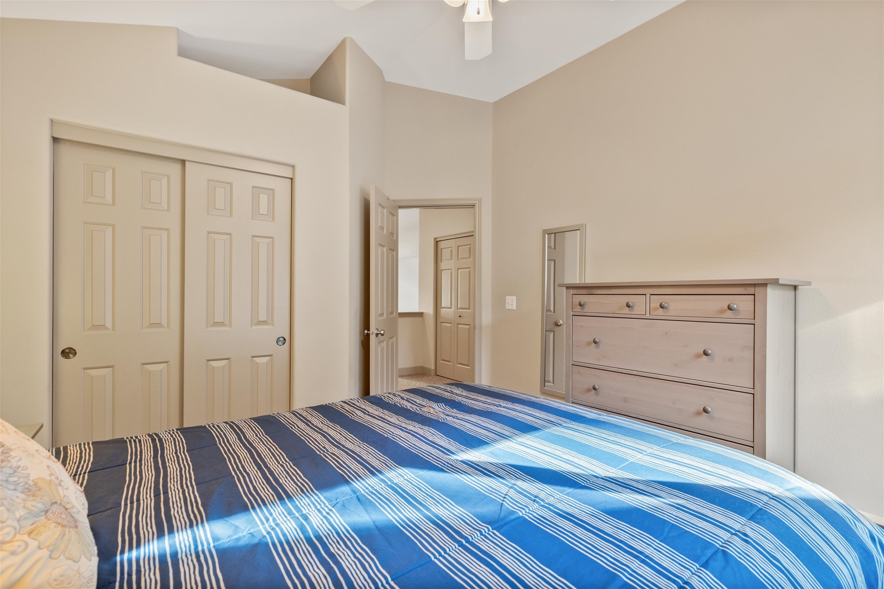 Queen guest room with ceiling fan, upper level.