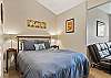 Queen guest room with sofa and work space, upper level.