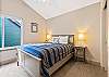 Queen guest room with ceiling fan, upper level.