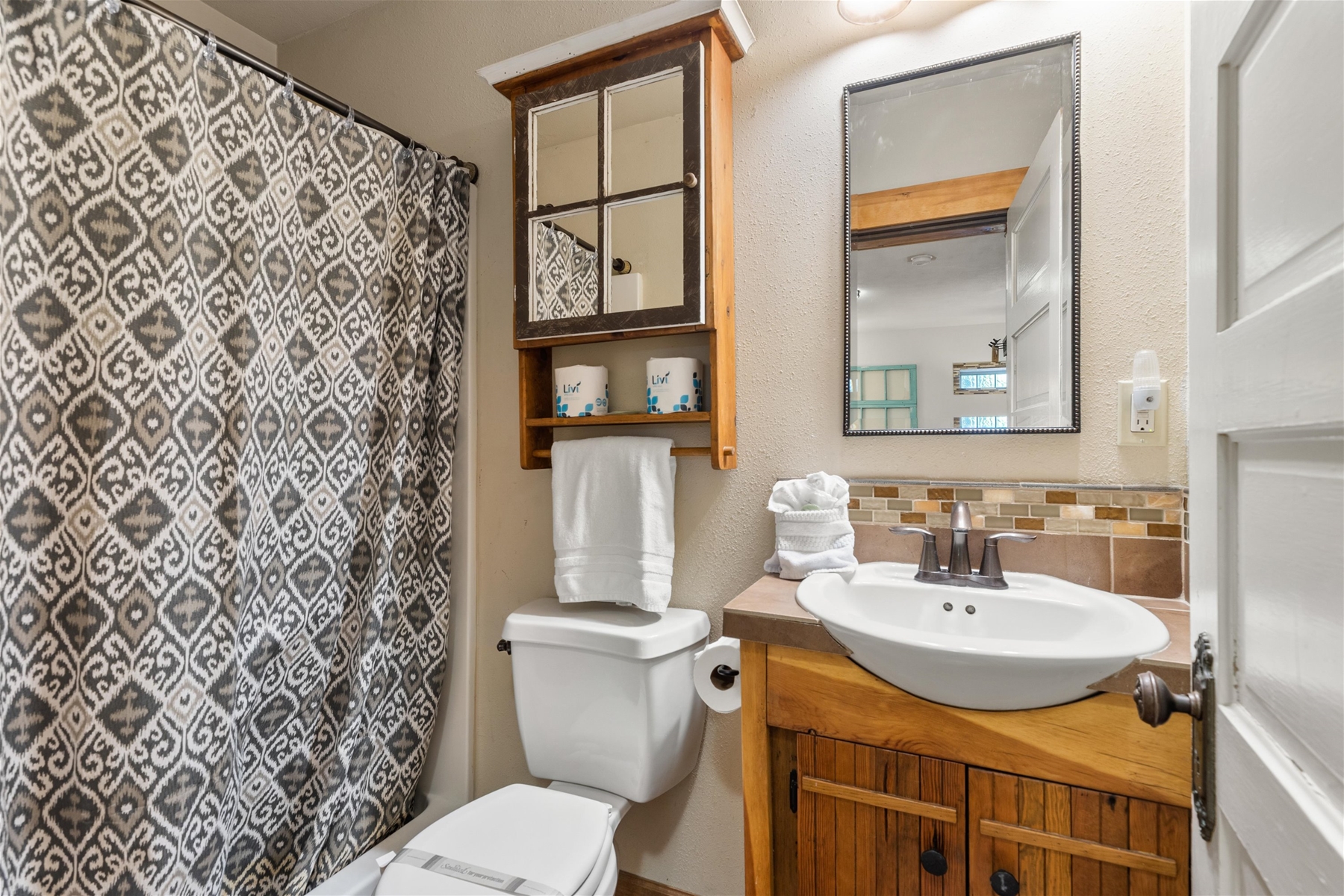 Tub/shower combo bathroom. 