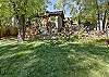 Expansive lawn view of the property, showcasing both the cottage and the studio. 