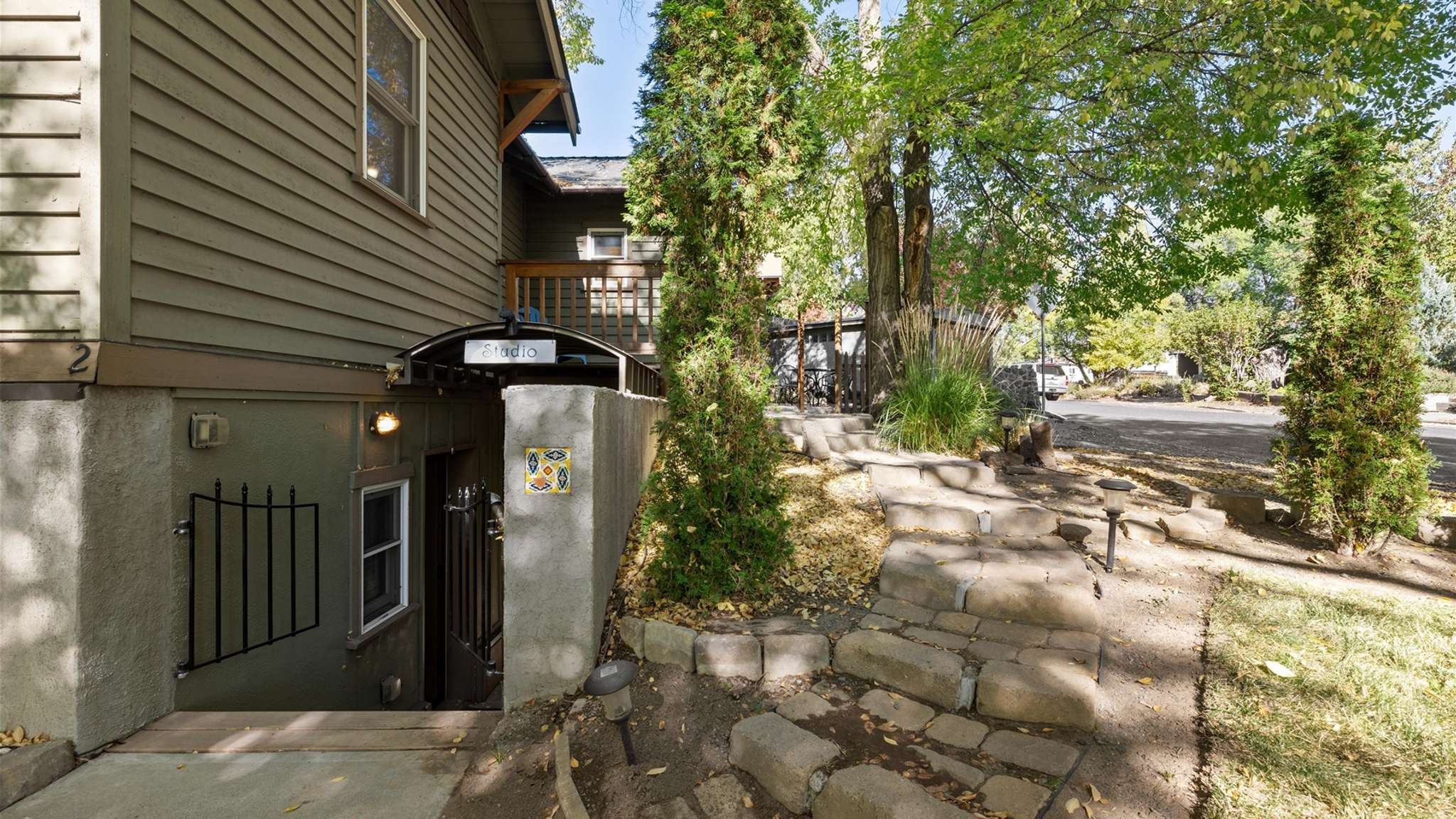 Private lower entrance to the studio with an iron gate.